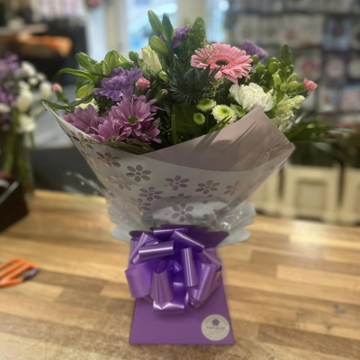 Violet - An impressive hand-tied of purple and white flowers, presented in a complimentary gift bag or box to make your gift feel extra special.